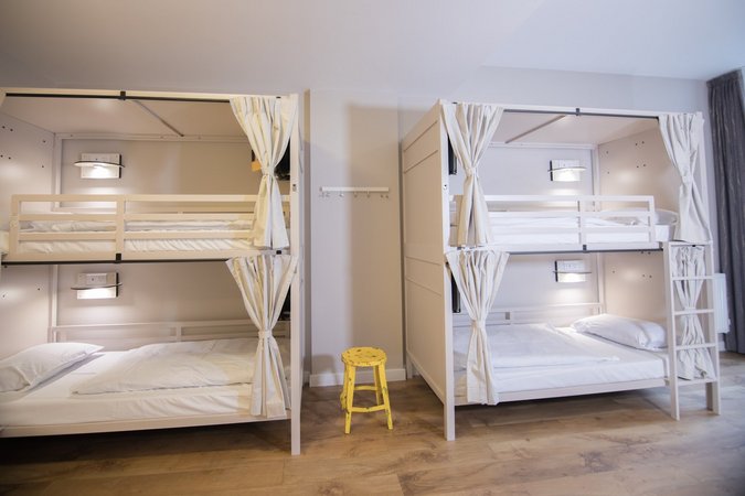 Enjoy your stay in our spacious dorm rooms featuring sleek white bunk beds