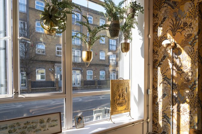 The golden sunlight filters through the large windows of WomCafé London