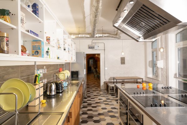 A glimpse into the spacious and neatly organized kitchen at Wombat's City Hostel London