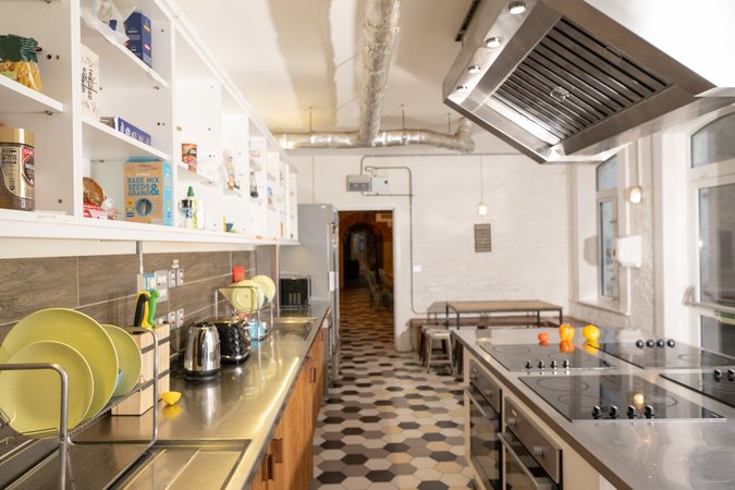 A glimpse into the spacious and neatly organized kitchen at Wombat's City Hostel London