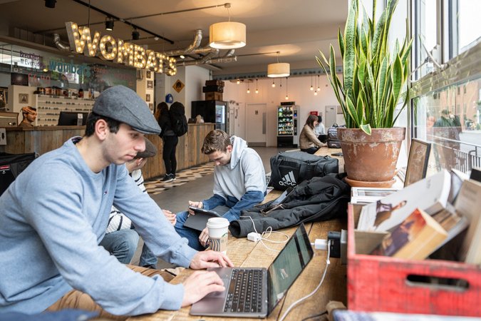 Guests relax and socialize in the bright and spacious lobby of Wombat's City Hostel London