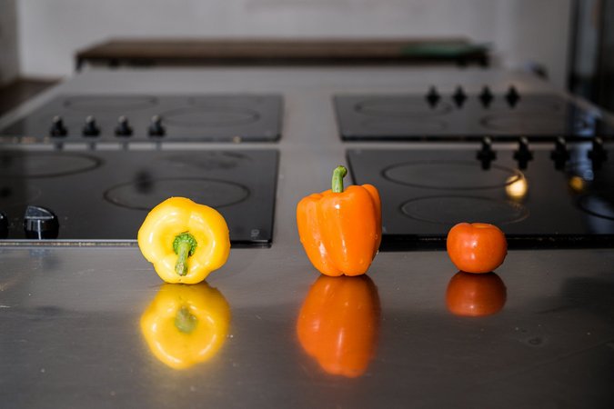 Colorful vegetables on a dark kitchen counter in Wombat's City Hostel London’s kitchen